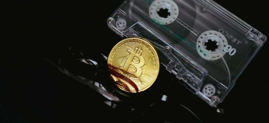 a bitcoin is sitting on top of a pair of scissors