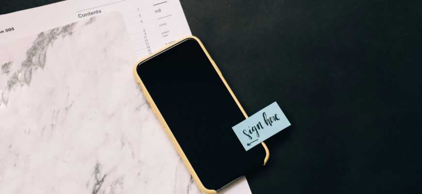 black smartphone on white pad