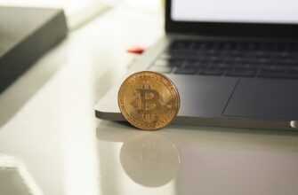 silver round coin on white table