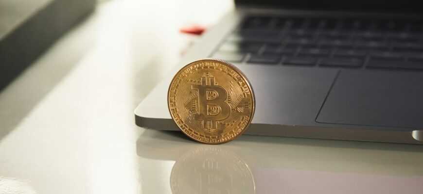 silver round coin on white table
