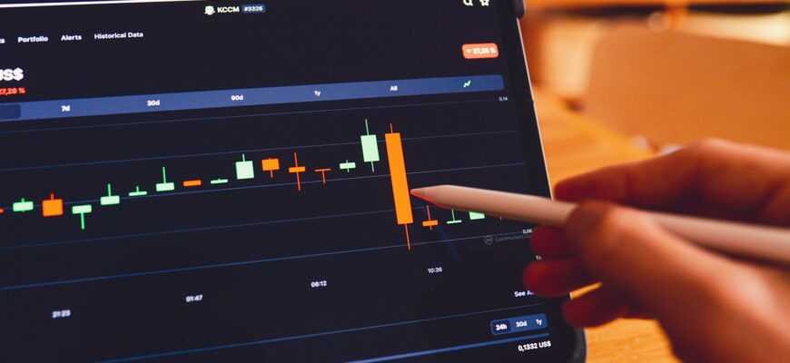 a person using a laptop computer with a chart on the screen