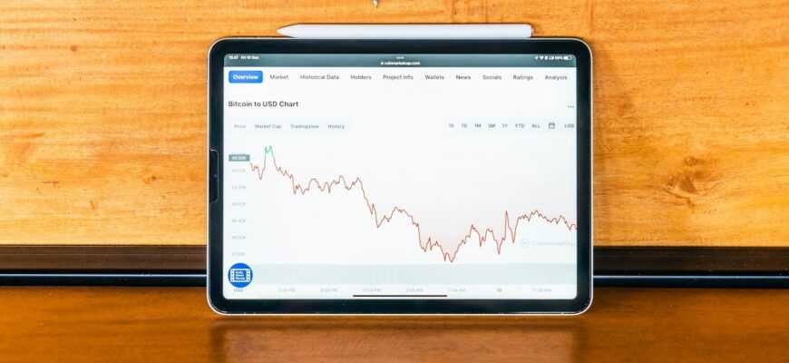 a tablet computer sitting on top of a wooden desk